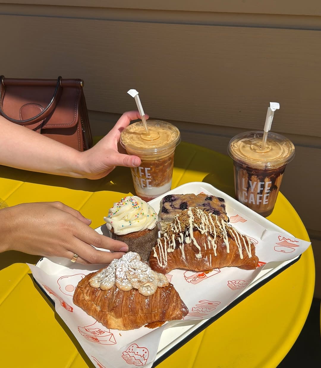 Iced coffees and pastries on a table at Lyfe Cafe