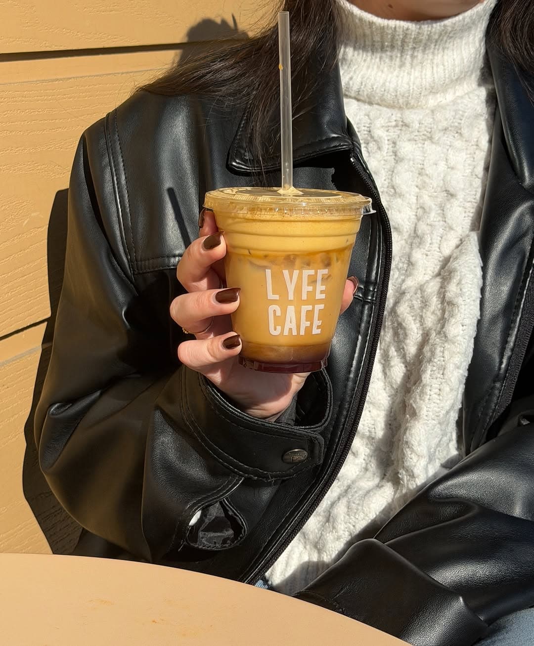 Customer enjoying a Lyfe Cafe iced latte